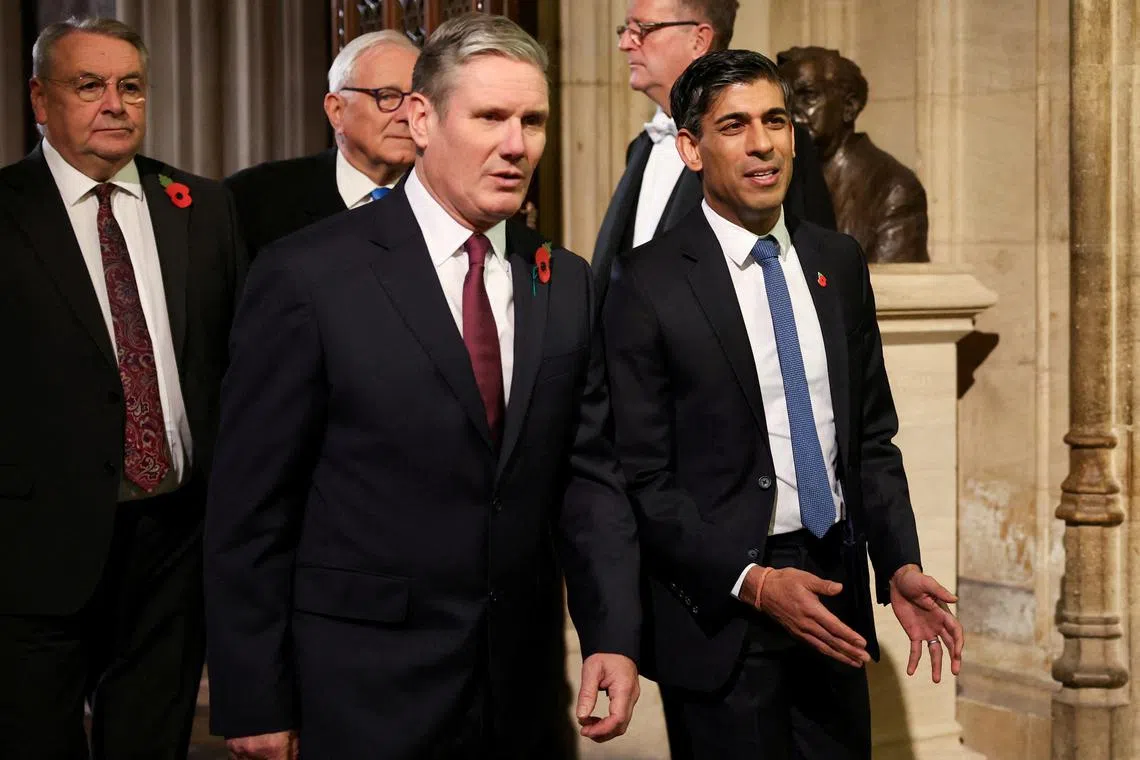 FILE PHOTO: Labour Party leader Sir Keir Starmer walks with Britain's Prime Minister Rishi Sunak during the State Opening of Parliament ceremony, at the Houses of Parliament, in London, Britain November 7, 2023. REUTERS/Hannah McKay/Pool/File Photo
