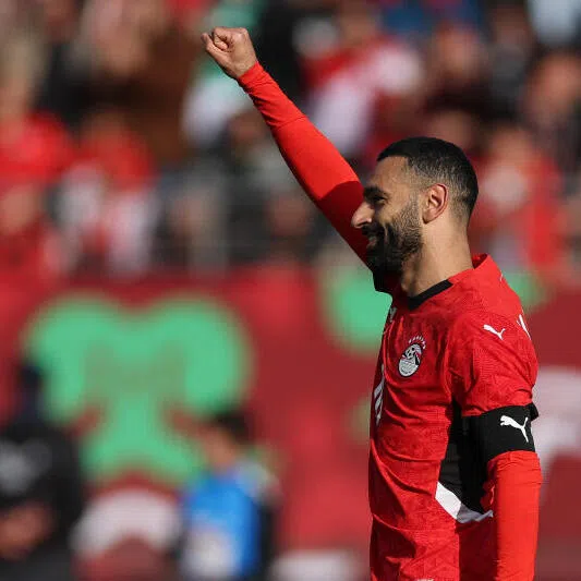 Egypt's forward Mohamed Salah celebrates scoring the team's first goal from a penalty.