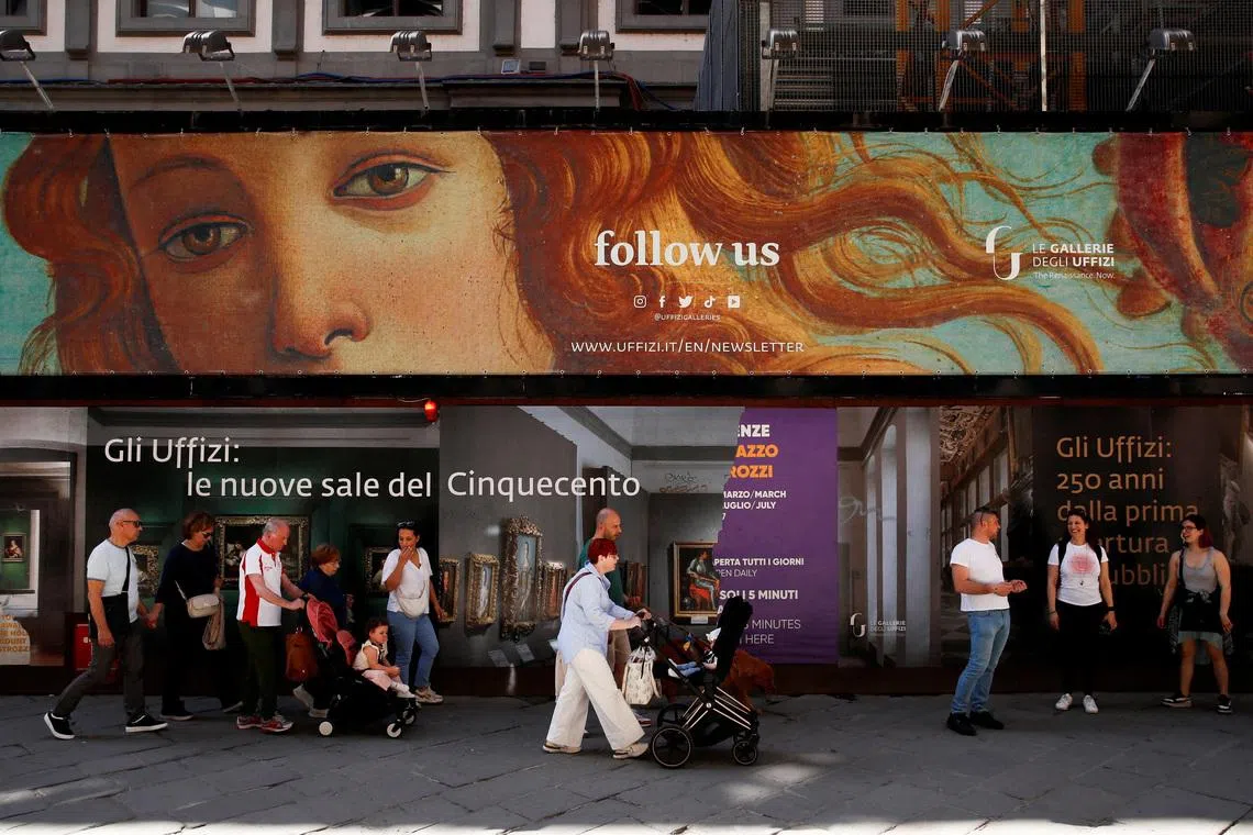 FILE PHOTO: People walk past the Uffizi Gallery Museum in Florence, Italy April 13, 2024. REUTERS/Alessandro Garofalo/File Photo