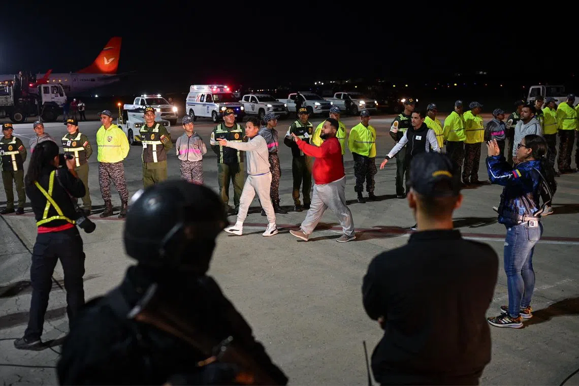 FILE PHOTO: Venezuelan migrants arrive on a deportation flight from the U.S. at the Simon Bolivar International airport in Maiquetia, La Guaira State, Venezuela February 10, 2025. REUTERS/Gaby Oraa/File Photo