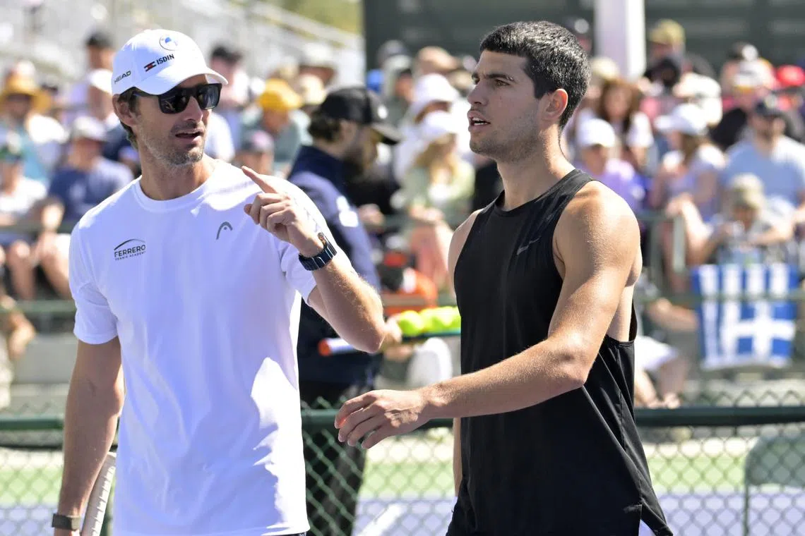 FILE PHOTO: Mar 6, 2024; Indian Wells, CA, USA;  Tennis coach Juan Carlos Ferrero talks with Carlos Alcaraz (ESP) on the practice courts during the BNP Paribas Open at the Indian Wells Tennis Garden. Mandatory Credit: Jayne Kamin-Oncea-USA TODAY Sports/ FILE PHOTO