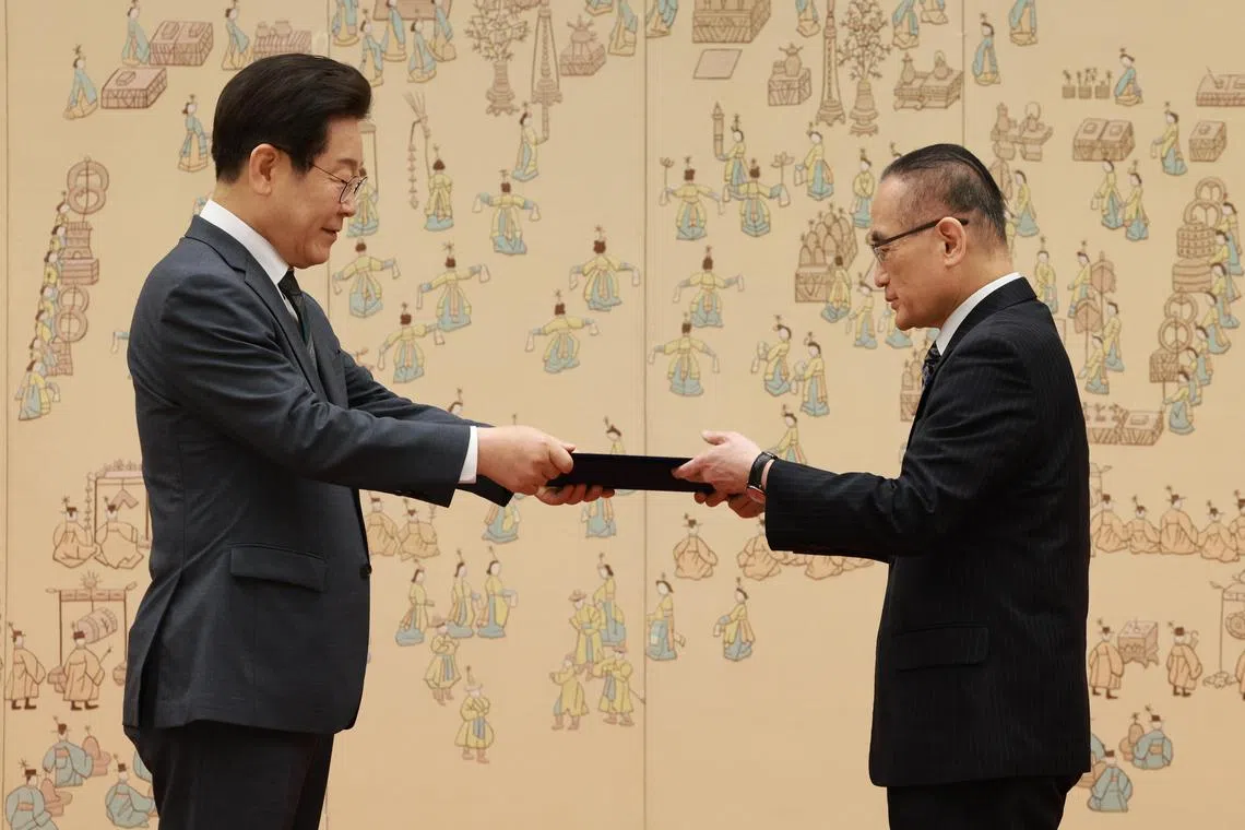 President Lee Jae Myung (left) presents National Security Adviser Wi Sung-lac with a letter of appointment at the presidential office in Seoul, South Korea, on July 4, 2025.