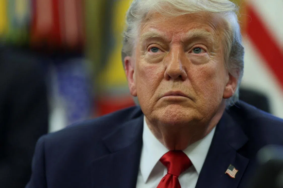 FILE PHOTO: U.S. President Donald Trump looks on, as he signs executive orders in the Oval Office at the White House in Washington, D.C., U.S., April 23, 2025. REUTERS/Leah Millis/File Photo