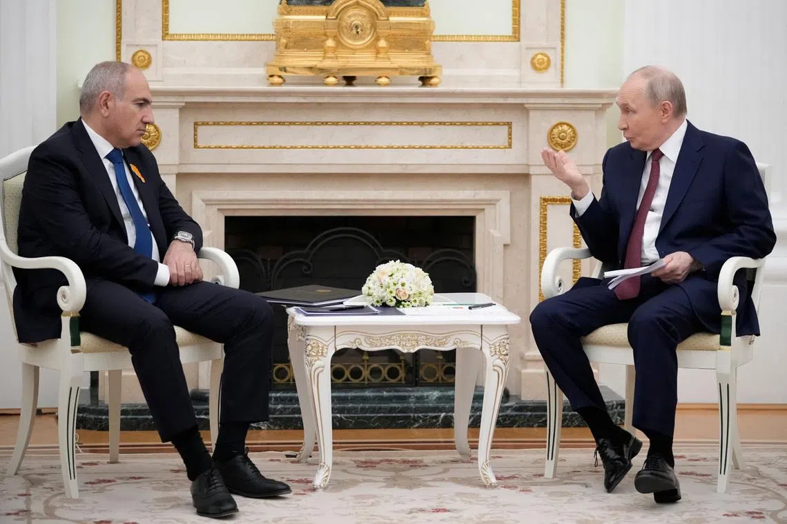 Russian President Vladimir Putin talks to Armenian Prime Minister Nikol Pashinyan during their meeting at the Kremlin in Moscow, Russia, April 1, 2026. Pavel Bednyakov/Pool via REUTERS