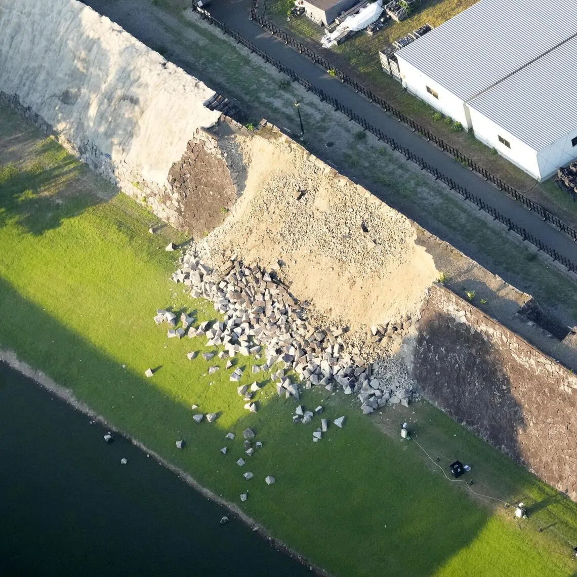 An aerial view shows a collapsed part of Kumamoto Castle’s stone walls after the earthquake on July 28.
