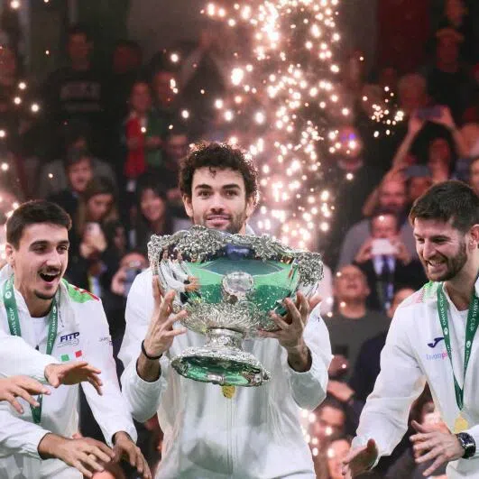 Italy's Matteo Berrettini (centre) surrounded by teammates as he lifts the David Cup trophy after their victory over Spain in Bologna, Italy.