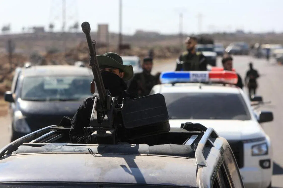 Syrian security forces take a position in the Mazraa area, near Sweida on July 14, 2025, following clashes between Bedouin tribes and local fighters in the predominantly Druze city. At least 89 people were killed in the southern Syrian province of Sweida as clashes between Sunni Bedouin tribes and Druze fighters raged for a second day on July 14, 2025, a monitor said. (Photo by Bakr ALkasem / AFP)