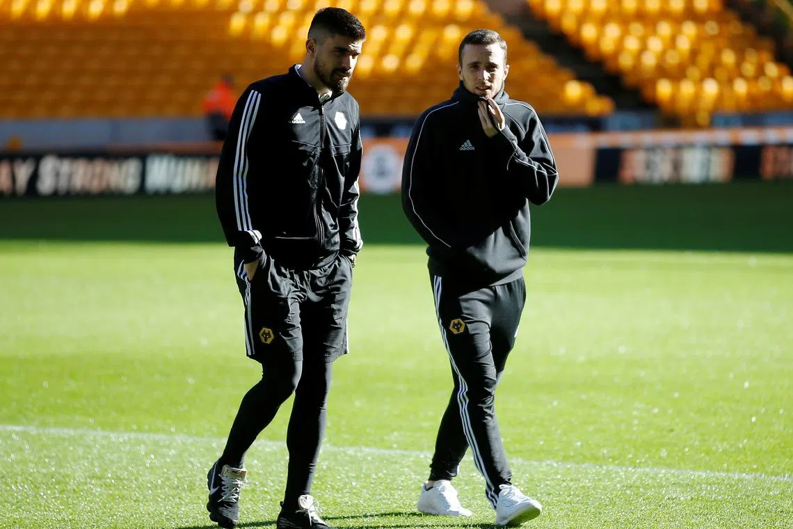 FILE PHOTO: Soccer Football - Premier League - Wolverhampton Wanderers v Norwich City - Molineux Stadium, Wolverhampton, Britain - February 23, 2020  Wolverhampton Wanderers' Diogo Jota and Ruben Neves inside the stadium before the match   Action Images via Reuters/Craig Brough/ File Photo