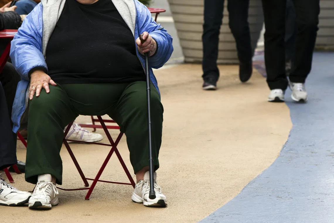 An overweight woman sits on a chair in Times Square in New York, May 8, 2012. REUTERS/Lucas Jackson/ File Photo