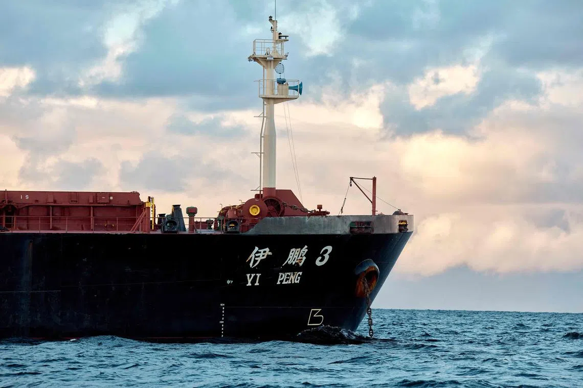 (FILES) The Chinese ship, the bulk carrier Yi Peng 3 is anchored and being monitored by a Danish naval patrol vessel (unseen) in the sea of Kattegat, near the City og Granaa in Jutland, Denmark, on November 20, 2024. Denmark's foreign minister said on December 19, 2024 that he expected a Chinese ship, anchored off Denmark and linked to two severed undersea cables, would be able to leave once an inspection which included four countries was completed. (Photo by Mikkel Berg Pedersen / Ritzau Scanpix / AFP) / Denmark OUT