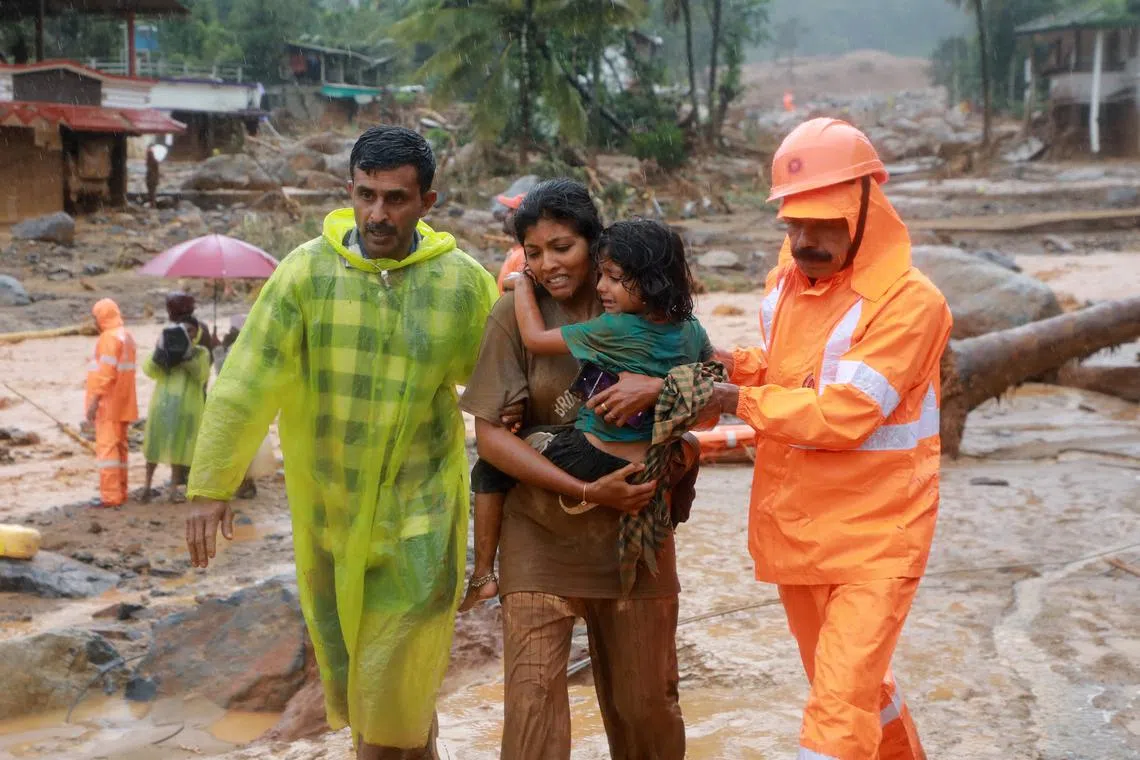 Rescuers help residents to move to a safer place, at a landslide site after multiple landslides in the hills, in Wayanad, in the southern state of Kerala, India, July 30, 2024. REUTERS/Stringer