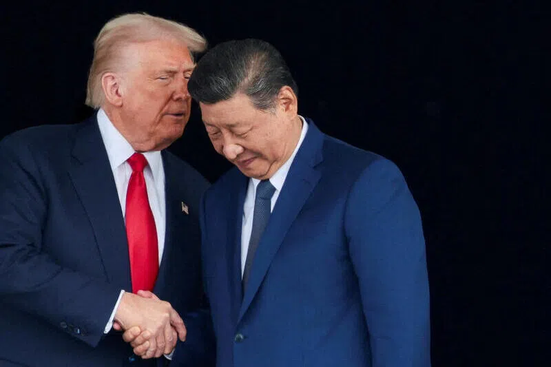US President Donald Trump and Chinese President Xi Jinping talk as they leave after a bilateral meeting at Gimhae International Airport, South Korea on the sidelines of the Apec summit.