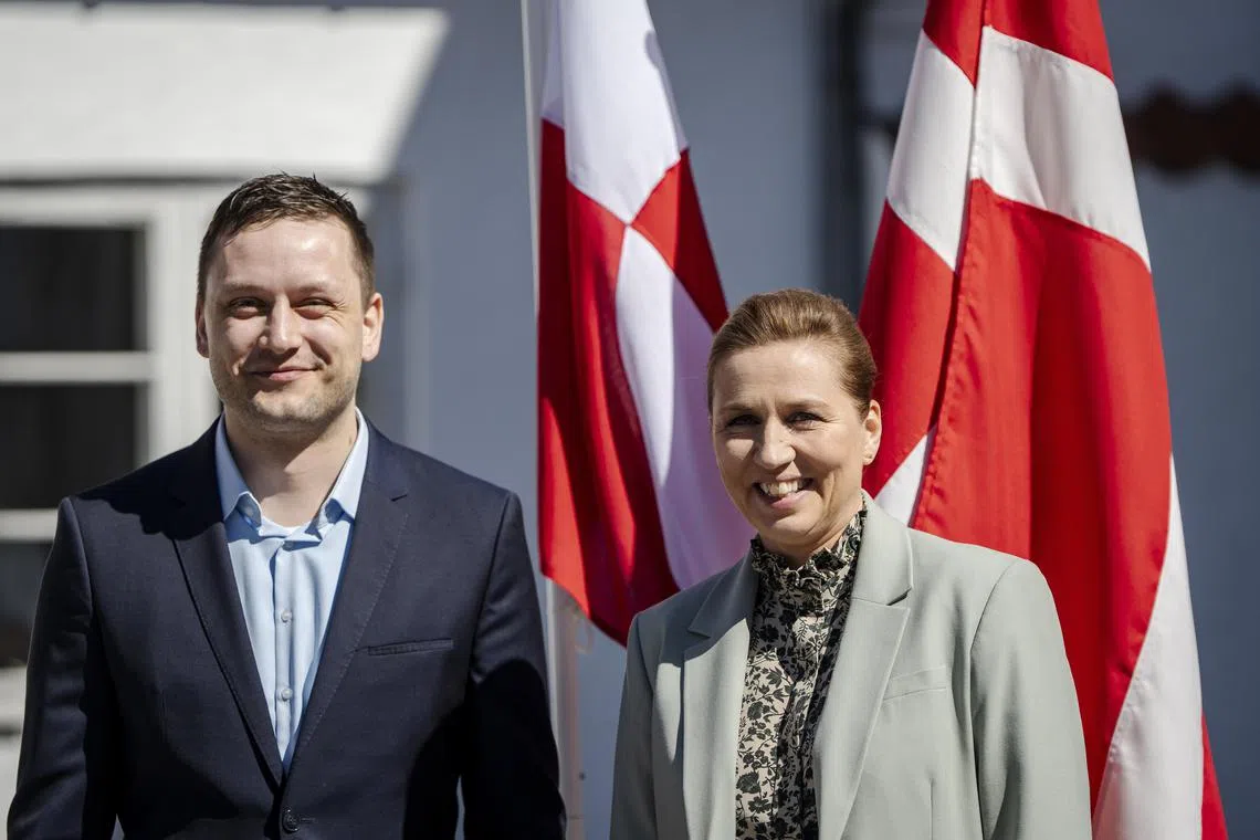 Greenland's new Prime Minister, Mr Jens-Frederik Nielsen (left), being welcomed to Denmark by Danish Prime Minister Mette Frederiksen on April 27.
