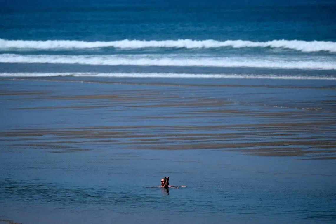 A woman swimming in the sea in Anglet as the heatwave sweeps across southwestern France, on June 17, 2026. 