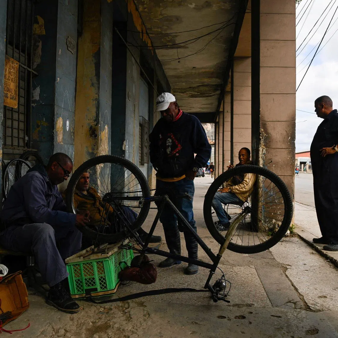 A man fixes a bicycle as Cubans brace for fuel scarcity measures after U.S. tightens oil supply blockade, in Havana, Cuba, February 6, 2026. REUTERS/Norlys Perez