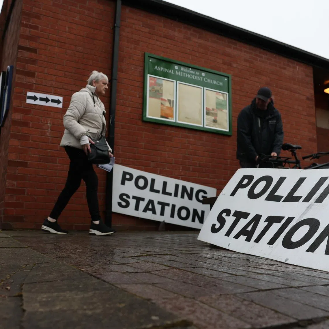 Voters arriving at a polling station in Manchester, Britain, on Feb 26.