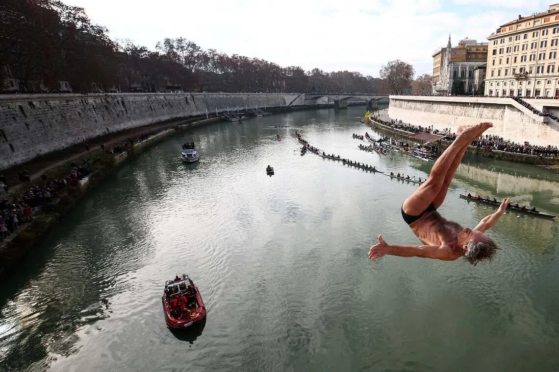 Marco Fois diving into the Tiber River from the Cavour bridge, as part of traditional New Year celebrations, in Rome, Italy, Jan 1, 2026. 