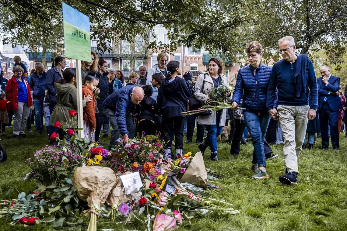 People lay flowers and candles at a makeshift memorial near the Erasmus University Medical Centre in Rotterdam.