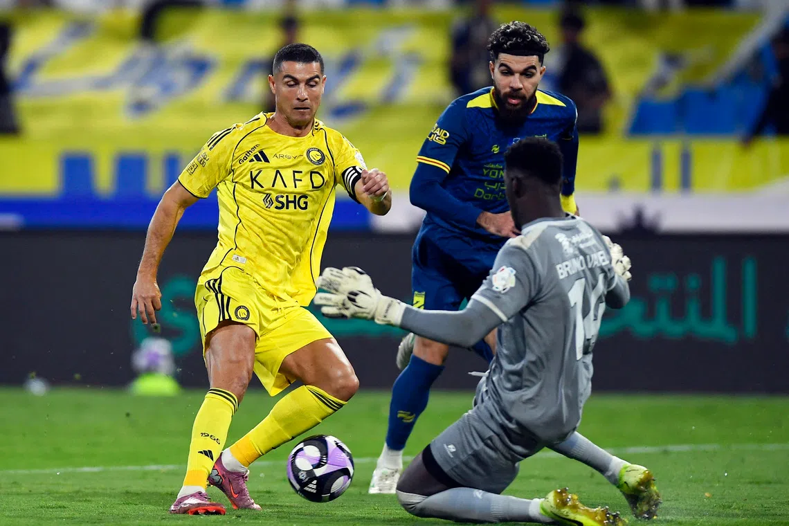 Soccer Football - Saudi Pro League - Al Hazem v Al Nassr - King Abdullah Sport City Stadium, Buraydah, Saudi Arabia - October 25, 2025 Al Nassr's Cristiano Ronaldo in action with Al Hazem's Bruno Varela REUTERS/Stringer