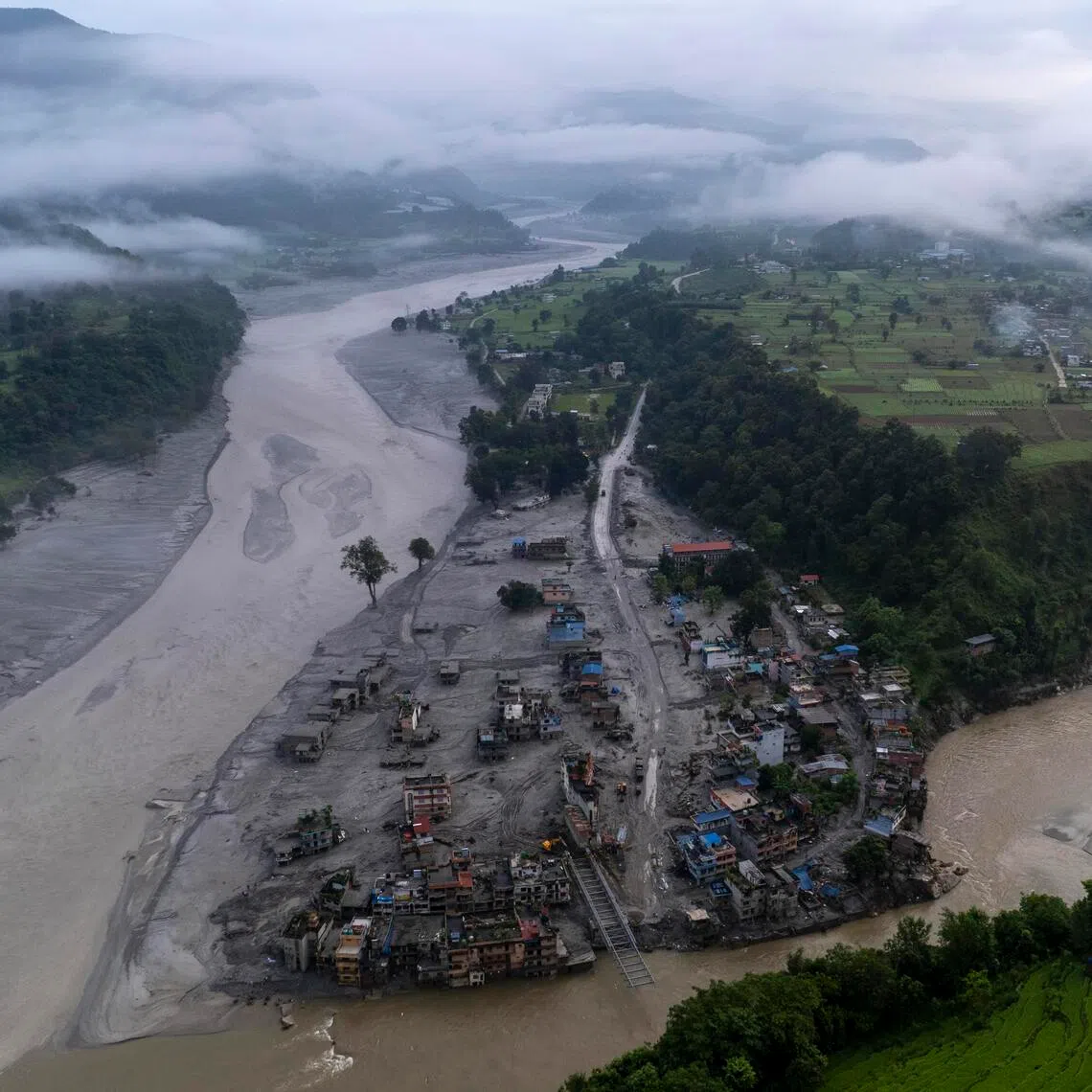 An aerial view of Devighat, one of the flood-hit villages in Nuwakot district, on Sept 7, when Nepal observed a national day of mourning. At least 1,380 people have been killed by the mudslide and more than 5,500 are missing in Nepal and Tibet.