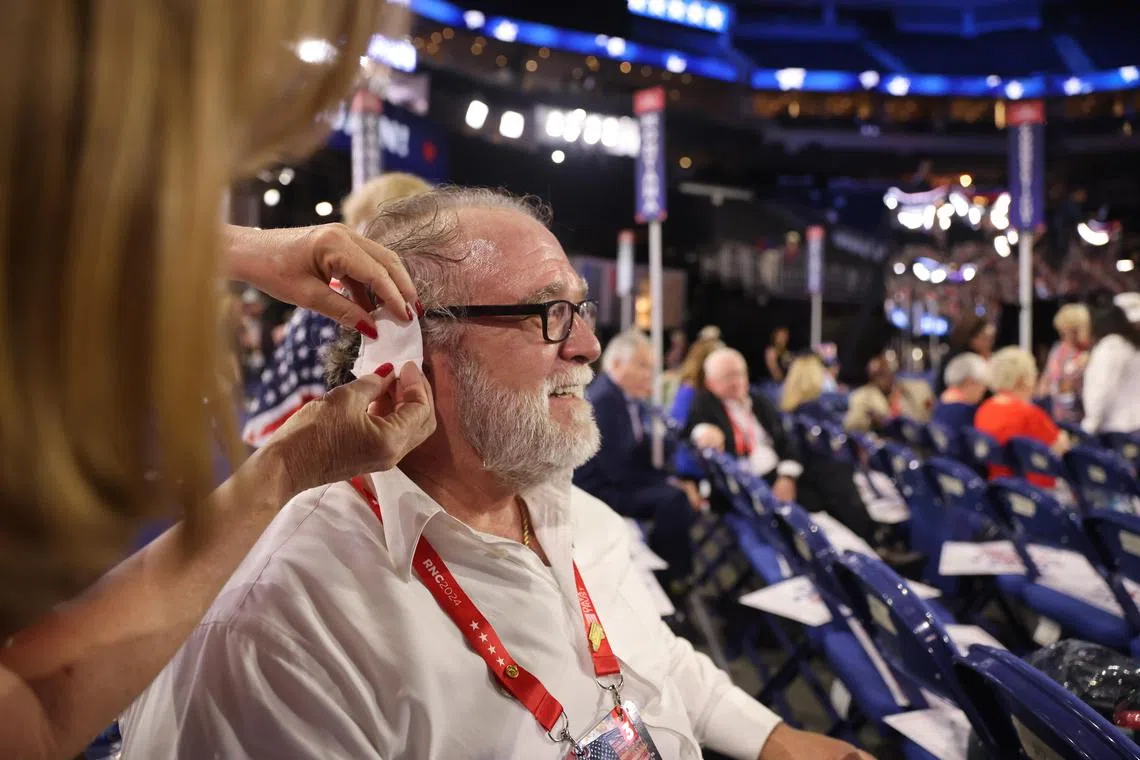 Convention attendees are wearing fake ear bandages, as a symbolic gesture of support for Donald Trump.