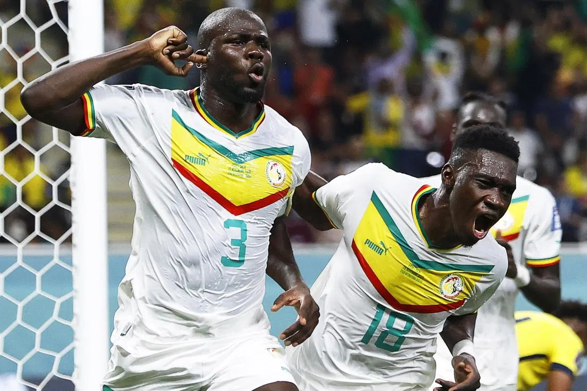 Senegal's Kalidou Koulibaly (No. 3) celebrating with teammate Ismaila Sarr (right) after scoring their winner against Ecuador to send them into the last 16.