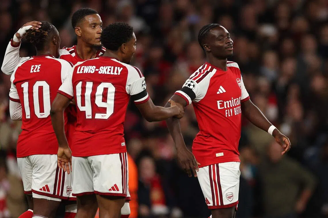 Arsenal’s midfielder Bukayo Saka (right) celebrates scoring the team’s third goal against Lille with teammates Ezri Konsa, Eberechi Eze and Myles Lewis-Skelly.