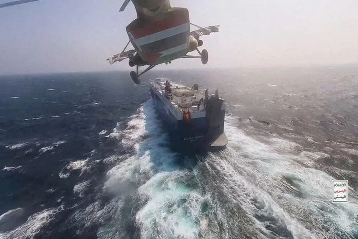 FILE PHOTO: Houthi military helicopter flies over the Galaxy Leader cargo ship in the Red Sea in this photo released November 20, 2023. Houthi Military Media/Handout via REUTERS/ File Photo