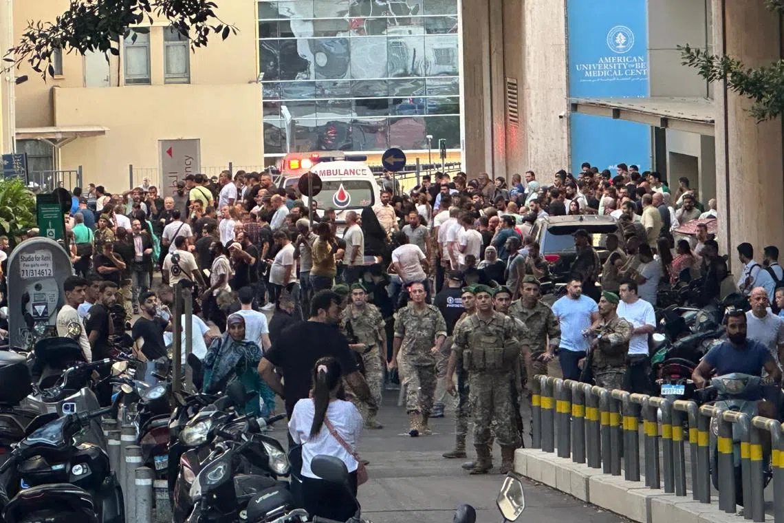 Lebanese soldiers and Hezbollah members gather outside a hospital where injured people were being transported, in Dahieh, Beirut, south Lebanon, on Sept 17, 2024.
