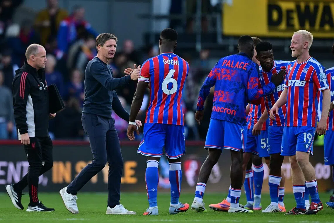 Crystal Palace manager Oliver Glasner congratulates his players after the win over Liverpool.
