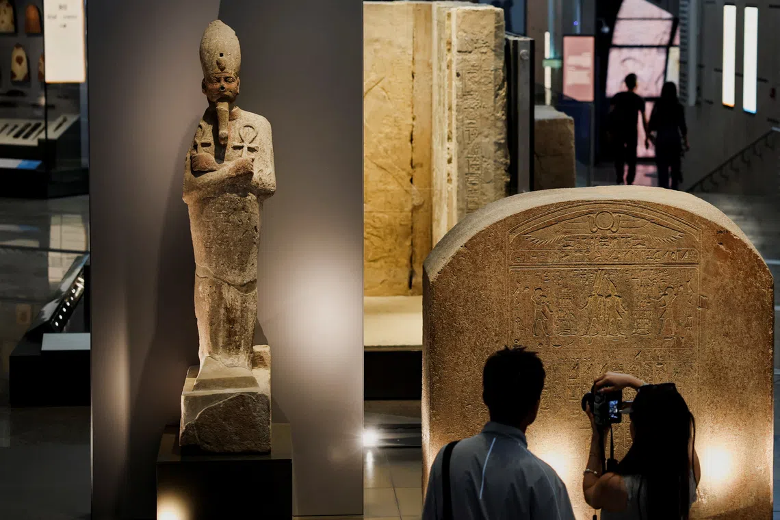 Tourists look at exhibits at the Grand Egyptian Museum (GEM), which is scheduled to officially open on November 1, 2025, following a partial opening last year, in Giza, Egypt, June 2, 2025. Egyptian officials hope the opening of the Grand Egyptian Museum will give a major boost to the tourism industry, providing an injection of foreign currency needed to keep the pound stable and ward off inflation. REUTERS/Amr Abdallah Dalsh
