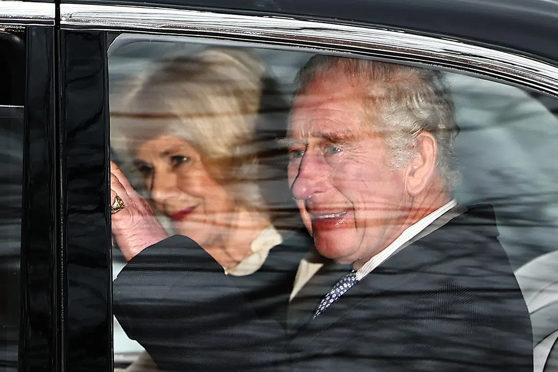 Britain's King Charles III and Britain's Queen Camilla wave as they leave by car from Clarence House in London, on Feb 6.