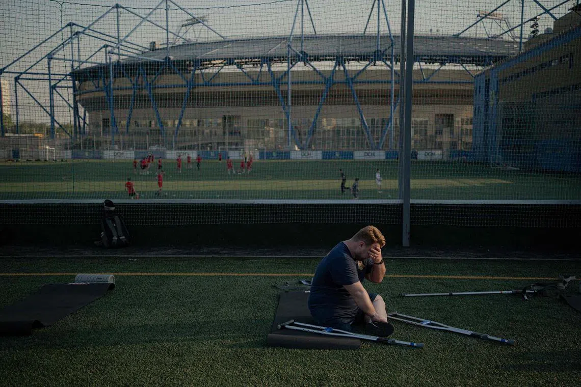 TOPSHOT - A team member sits down during a training session of the football team “Unbreakable” on one of the football fields of the Metalist Stadium in Kharkiv, on April 21, 2025, amid the Russian invasion of Ukraine. The soccer club was founded a month ago in Kharkiv by veterans of the Russian-Ukrainian war for war veterans and civilians with amputated limbs. So far, the team has held six training sessions and is preparing for future tournaments (Photo by Ivan SAMOILOV / AFP)