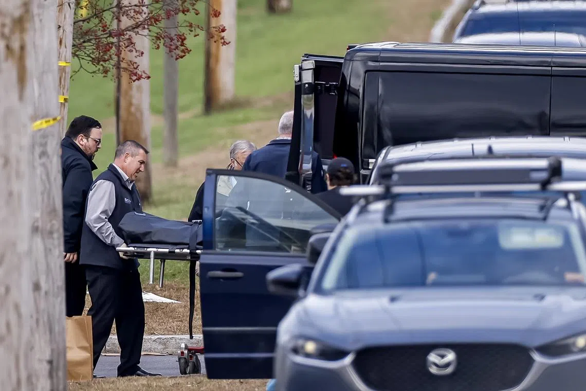 A body is removed from inside Schemengees Bar and Grille, following a multiple fatality mass shooting in Lewiston, Maine, US, on Oct 26.