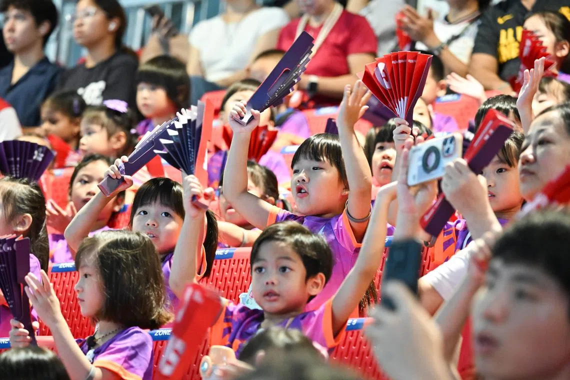 Little Team Nila volunteers cheering on swimming athletes at World Aquatics Championships Arena on Aug 1.