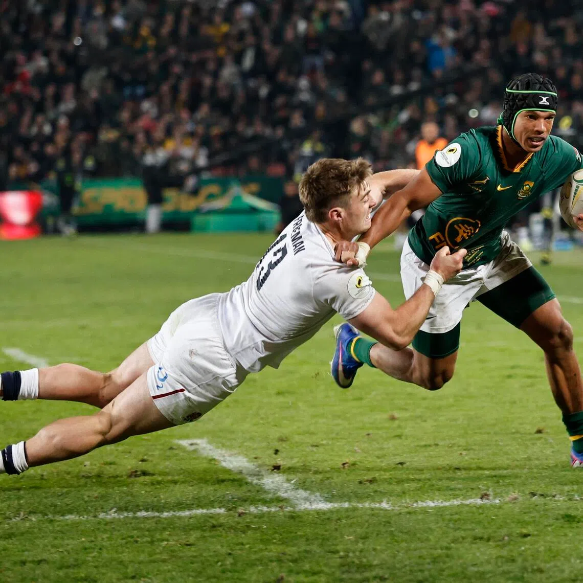 epa13086903 South Africa's Kurt-Lee Arendse (R) and England's Tommy Freeman in action during the Rugby Nations Championship match South Africa against England, in Johannesburg, South Africa, 04 July 2026.  EPA/Kim Ludbrook