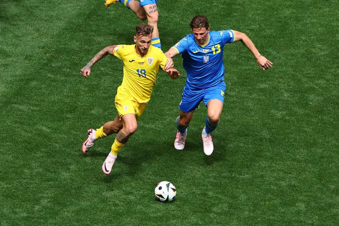 Soccer Football - Euro 2024 - Group E - Romania v Ukraine - Munich Football Arena, Munich, Germany - June 17, 2024 Romania's Razvan Marin in action with Ukraine's Illia Zabarnyi REUTERS/Leonhard Simon