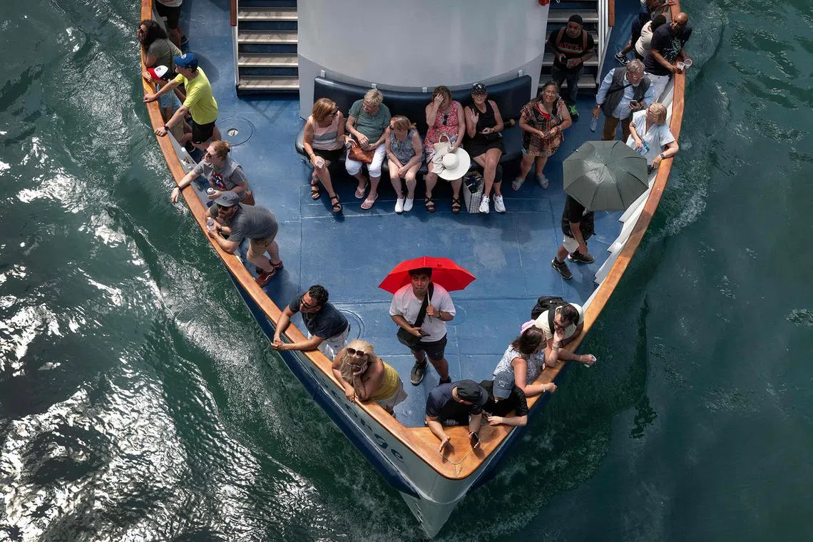 People riding a tour boat on the Chicago River as temperatures climbed into the mid-90s on June 23, 2025, in Chicago, Illinois. 