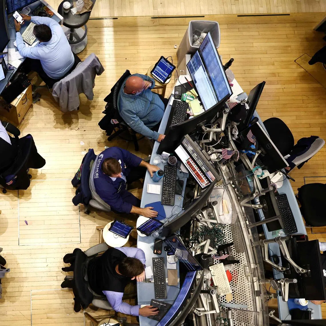 Traders work on the floor of the New York Stock Exchange (NYSE) at the opening bell, in New York City on Sept 28.