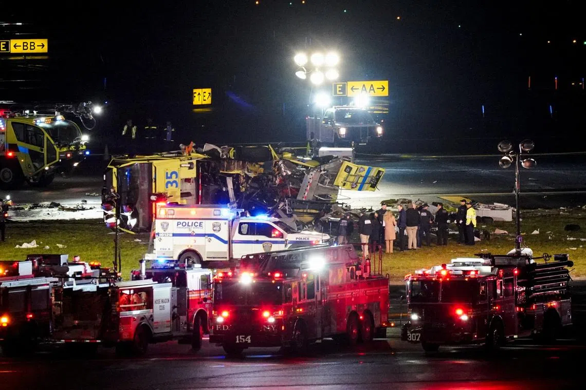 Emergency crews work around a ground vehicle following a collision between the vehicle and an Air Canada Express jet at LaGuardia Airport in Queens, New York, U.S. March 23, 2026. REUTERS/Bing Guan