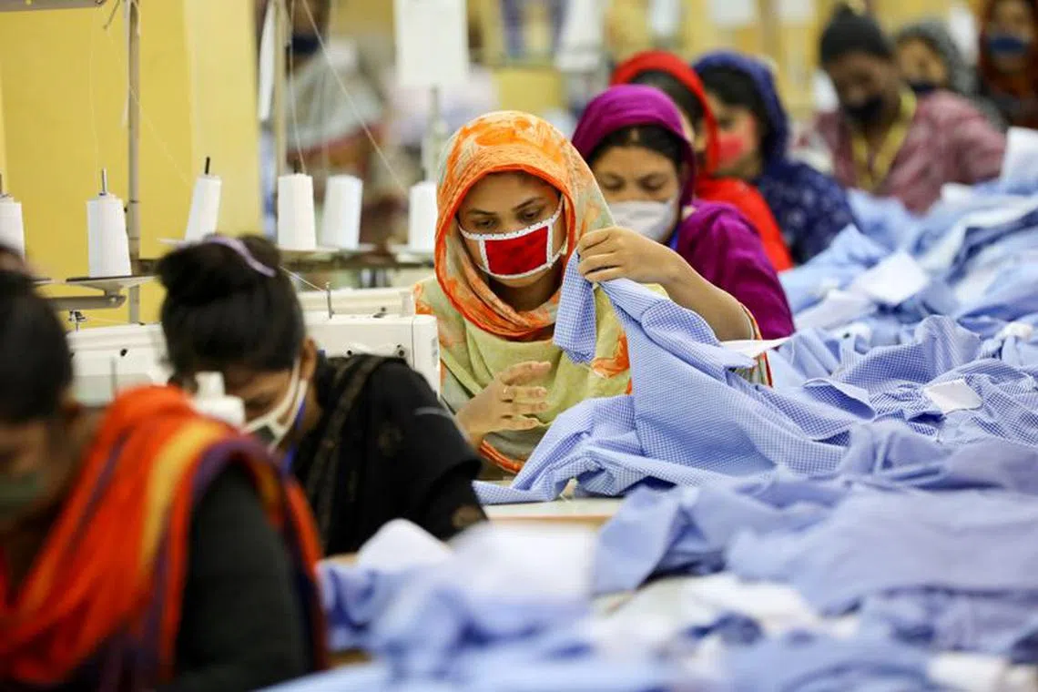 Women work in a garment factory, as factories reopened after the government has eased the restrictions amid concerns over coronavirus disease (COVID-19) outbreak in Dhaka, Bangladesh, May 3, 2020. REUTERS/Mohammad Ponir Hossain/File Photo