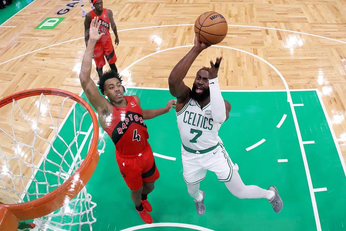 Jaylen Brown of the Boston Celtics takes a shot against Scottie Barnes of the Toronto Raptors at TD Garden.