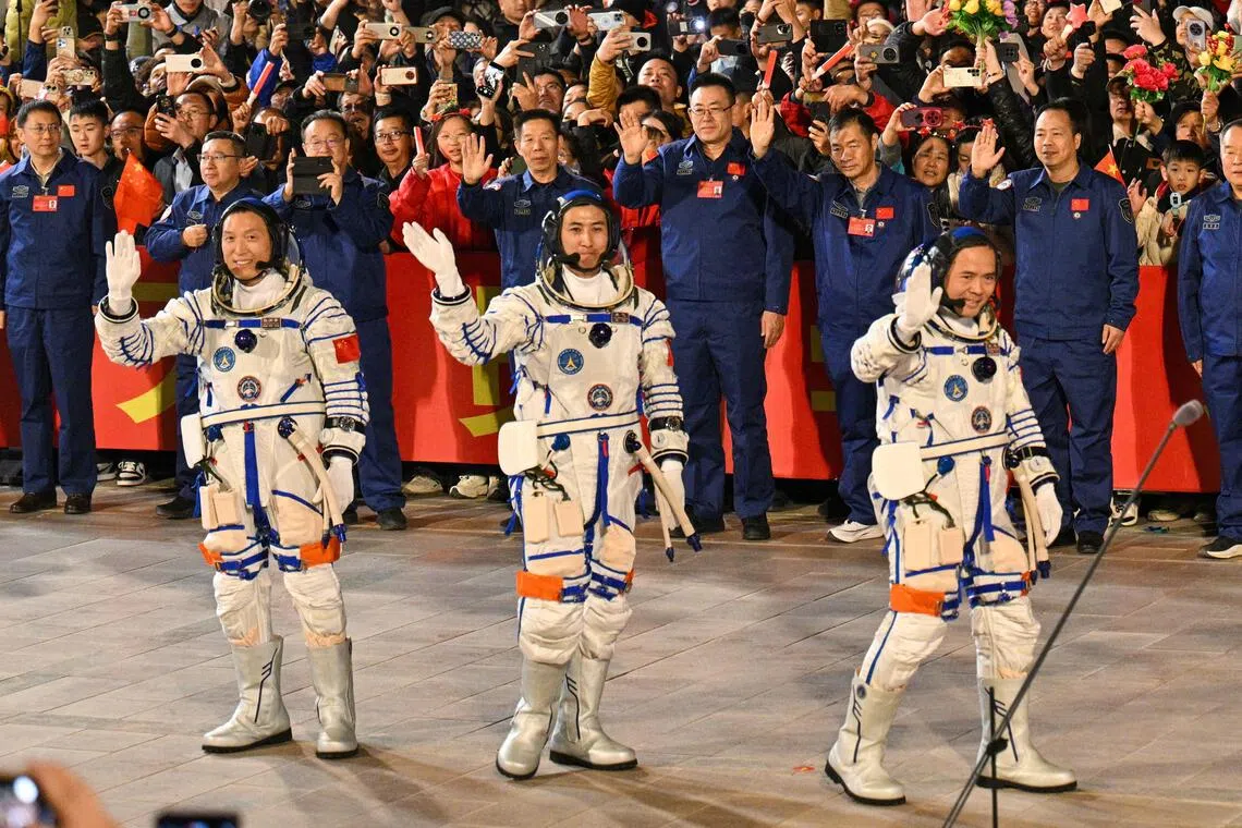 Astronauts (from left) Zhang Hongzhang, Wu Fei, and Commander Zhang Lu attending a departure ceremony before boarding a bus to take them to the Shenzhou-21 spaceship, on Oct 31.