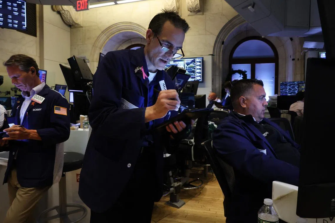 Traders work on the floor of the New York Stock Exchange, in New York City.