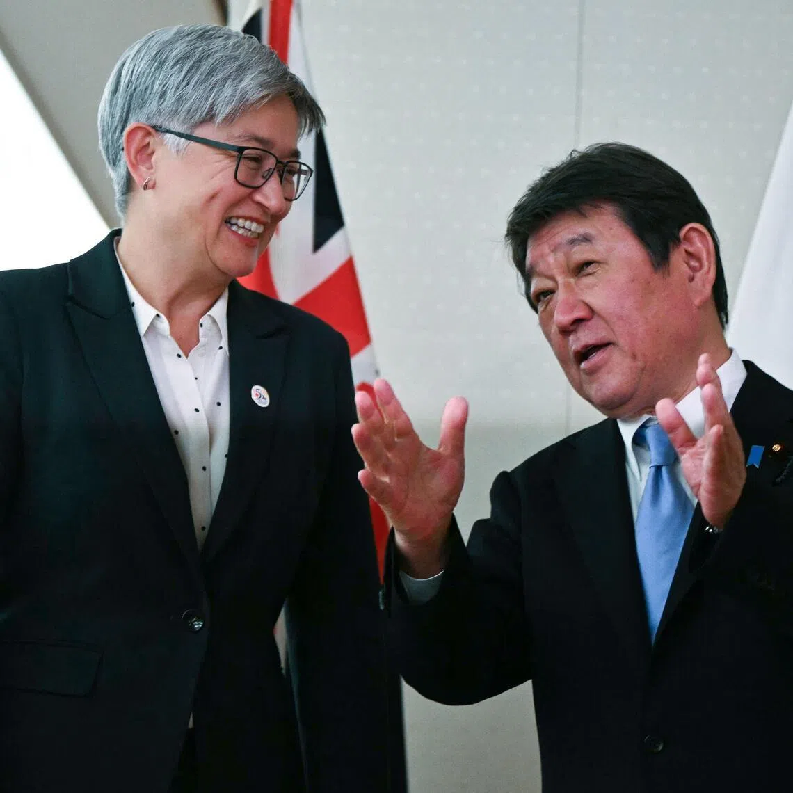 Japanese Foreign Minister Toshimitsu Motegi (right) speaks to Australian Foreign Minister Penny Wong at the Foreign Ministry in Tokyo on April 28.