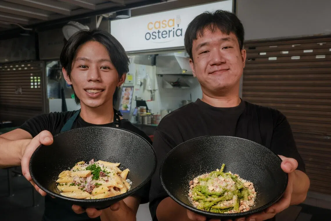 Jerome Chin (left) and Michael Lam with plates of Penne Carbonara and Linguine Pesto at their hawker stall, Casa Osteria, at Chomp Chomp Food Centre.