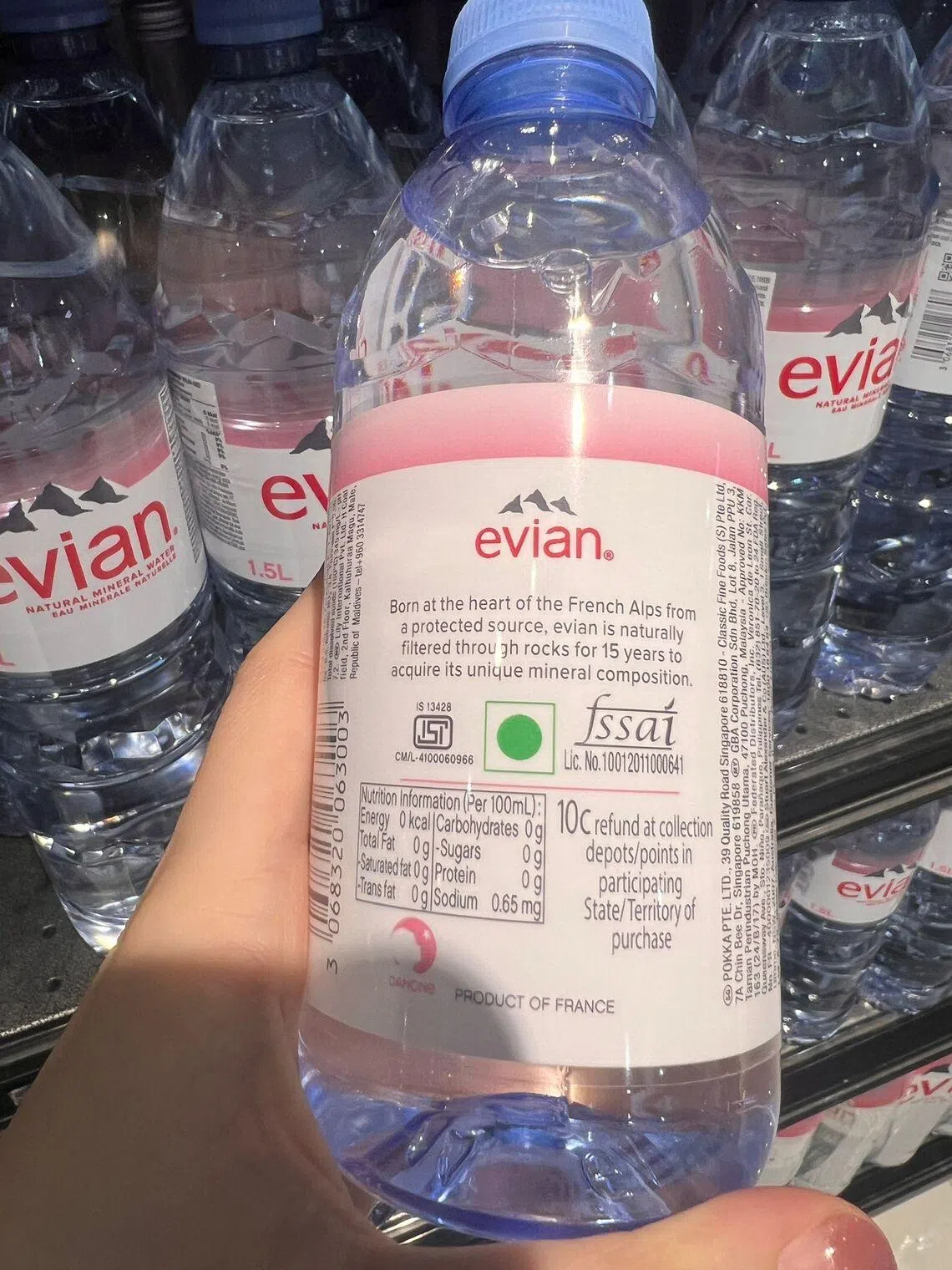 An Evian bottle bearing a foreign 10 cent return logo, designed for overseas recycling schemes.