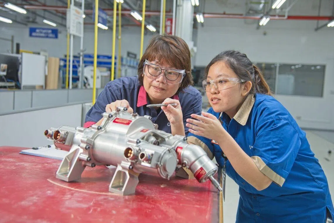 Senior manufacturing engineer Kwa Shu Ting (right) has an aerospace career at Collins Aerospace.