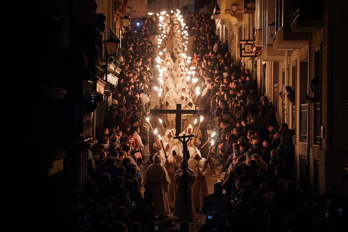 Penitents of the Christ of the Good Death brotherhood taking part in their Holy Monday procession during Holy Week in the northwestern Spanish town of Zamora on April 15, 2025. Christian believers around the world mark the Holy Week of Easter in celebration of the crucifixion and resurrection of Jesus Christ. 