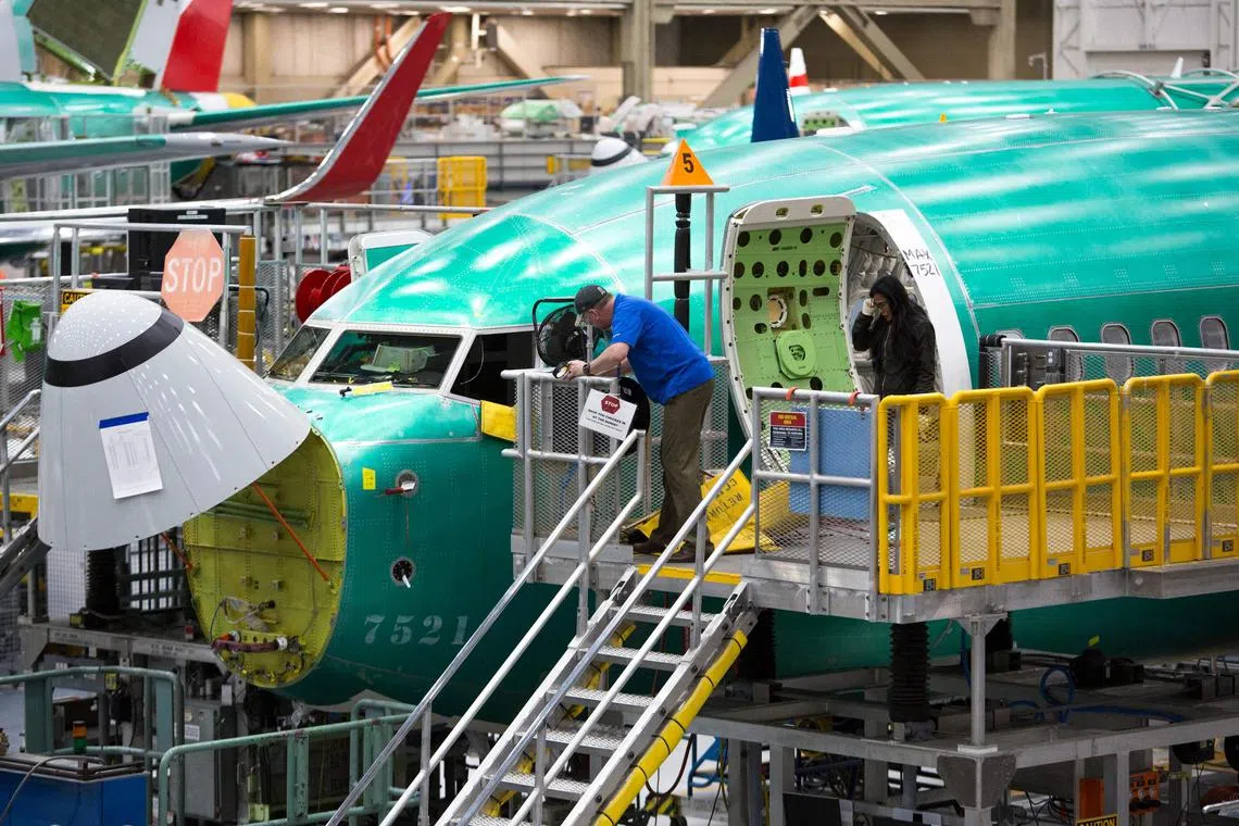 Employees work on Boeing 737 Max airplanes at its factory in Renton, Washington on March 27, 2019. 